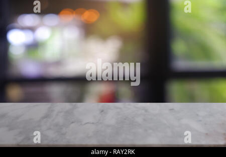 empty white marble stone table in front of abstract blurred background of cafe and coffee shop interior. can be used for display or montage product. Stock Photo