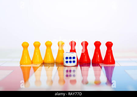 Picture of red and yellow pawns with dice on the ludo board game. Stock Photo