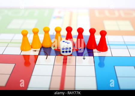 Picture of red and yellow pawns with dice on the ludo game. Stock Photo