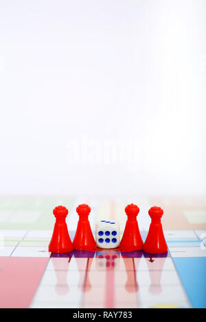 Picture of red pawns with dice on the ludo game. Stock Photo