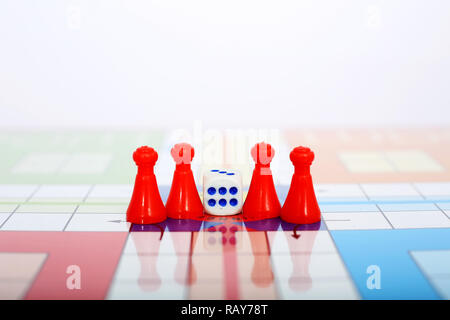 Portrait of red pawns with dice on the ludo game. Stock Photo