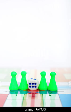 Picture of green pawns with dice on the ludo game. Stock Photo