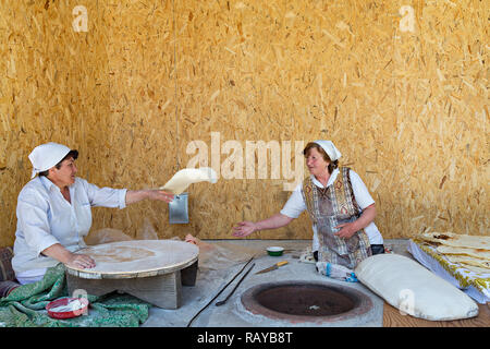 Armenian local women make Armenian bread known as lavash, in Garni, Armenia. Stock Photo