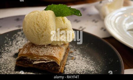 Typical Lebanese cake of baklava with vanilla ice cream Stock Photo