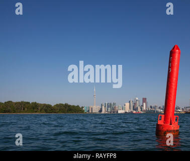 Bouy boat ship marker in Lake Ontario at Cherry Beach in Toronto Canada against a cityscape of Downtown Toronto, Ontario, Canada. Stock Photo