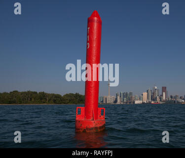 Bouy boat ship marker in Lake Ontario at Cherry Beach in Toronto Canada against a cityscape of Downtown Toronto, Ontario, Canada. Stock Photo