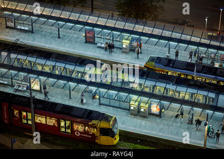 Manchester at night a busy Castlefield metrolink tram station stop Stock Photo