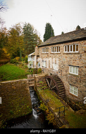 Marpel Bridge in Stockport, Cheshire a water wheel on the side of a house on a stream connecting with the River Goyt in the village Stock Photo