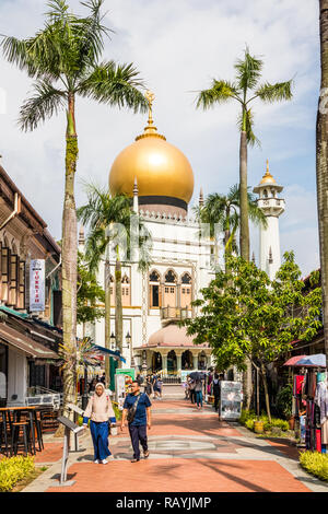 Singapore - 22nd December 2018: Tourists on Arab Street with the Sultan mosque in the background.  This is in the Kampong Glam area Stock Photo