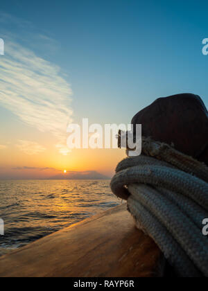 Sunset at the Sailboat deck while cruising in the Cyclades in Greece Stock Photo