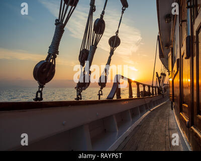 Sunset at the Sailboat deck while cruising in the Cyclades in Greece Stock Photo