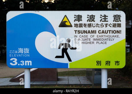 Beppu, Japan - November 1, 2018: National sign with Tsunami Caution placed in every city near the coast at Kyushu, Japan Stock Photo