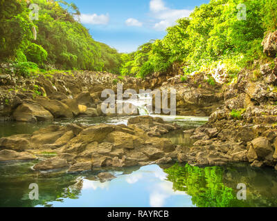 Beautiful sky reflected in the calm waters of Black River Gorges National Park, the largest protected forest of Mauritius, Indian Ocean, Africa. Scenic landscape of popular travel destination. Stock Photo