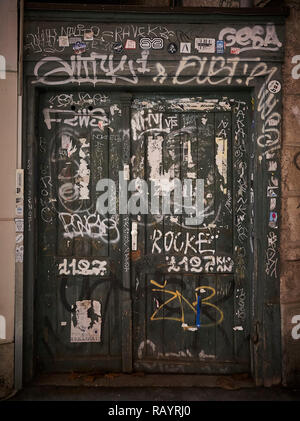 Old wooden door with graffiti Stock Photo