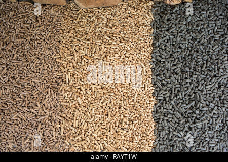 Three different kind of wooden pellets- pine, oak, sunflower pellets Stock Photo