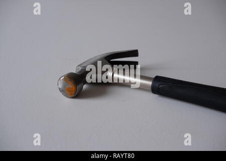 A rusty hammer with a black handle on a white background Stock Photo