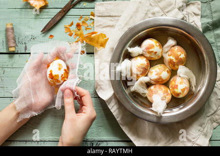 Eggs with a pattern onion peels. Preparation of Easter eggs for dying with onion peels. Stock Photo