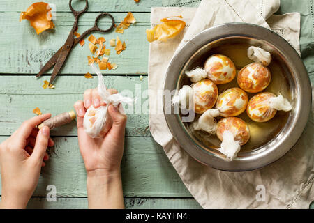 Eggs with a pattern onion peels. Preparation of Easter eggs for dying with onion peels. Stock Photo