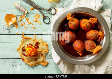 Eggs with a pattern onion peels. Preparation of Easter eggs for dying with onion peels. Stock Photo