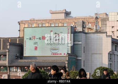 XI'AN, SHAANXI, CHINA -8 DECEMBER 2018: view of a billboard in downtown of Xian, with the message 'a drop of sweat and a grain of rice' Industry and C Stock Photo