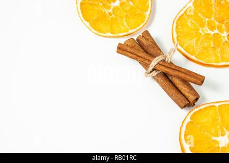 Top view, Orange slice and cinnamon sticks on a white background, space for text Stock Photo