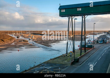 The quay at Wells-next-the-Sea behind the salt marshes on the north Norfolk coast. Stock Photo