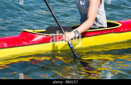Close-up of female kayaker paddling through water rapids Stock Photo