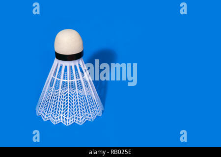Badminton shuttlecock isolated on the blue background Stock Photo