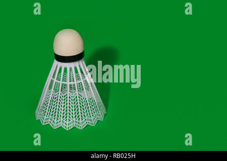 Badminton shuttlecock isolated on the green background Stock Photo