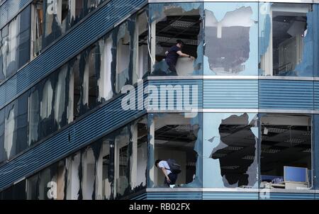 Beijing, China. 17th Sep, 2018. Staff members clean up offices ravaged by Super Typhoon Mangkhut in Kowloon of south China's Hong Kong, Sept. 17, 2018. Credit: Wang Shen/Xinhua/Alamy Live News Stock Photo