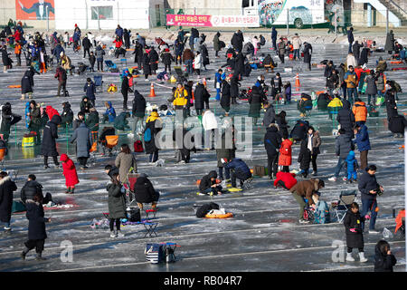 Hwacheon, South Korea. 5th Jan, 2019. People fish for trouts on a frozen river during the Sancheoneo Ice Festival in Hwacheon, South Korea, Jan. 5, 2019. As one of the biggest winter events in South Korea, the annual three-week festival draws people to the frozen Hwacheon river, where organizers drill fishing holes in the ice and release trouts into the river during the festival period. This year the festival lasts from Jan. 5 to Jan. 27. Credit: Wang Jingqiang/Xinhua/Alamy Live News Stock Photo