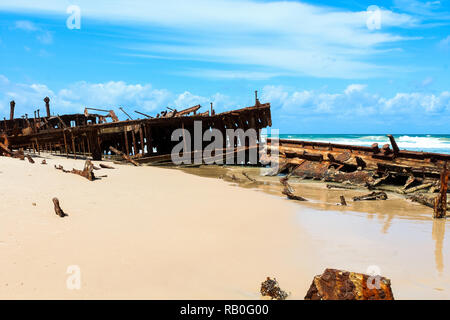 Close-up of Maheno Shipwreck on Fraser Island on a sunny summer day with blue sky and clouds without tourists / no people (Fraser Island, Australia) Stock Photo