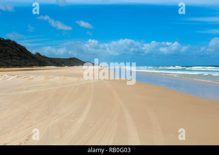 Empty and deserted Seventy-Five Mile Beach on Fraser Island during summer with bus tracks (Fraser Island, Queensland, Australia) Stock Photo