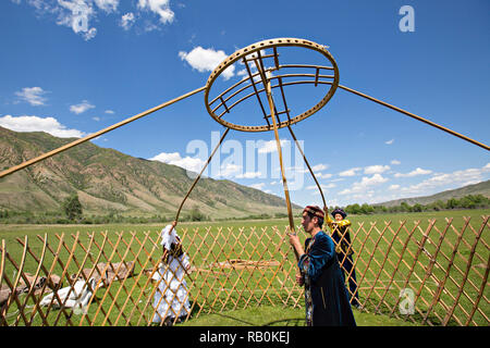 Kazakh people building a nomadic tent known as yurt. Stock Photo