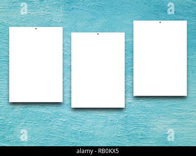 Three blank frames on aqua plaster wall background Stock Photo