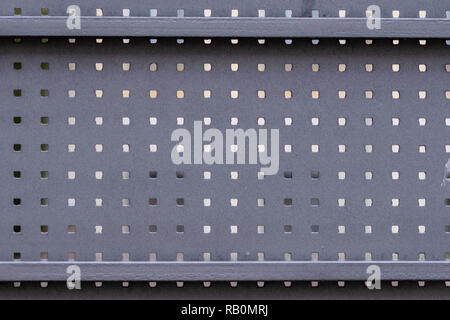 Part of a metal gate with square holes. Stock Photo