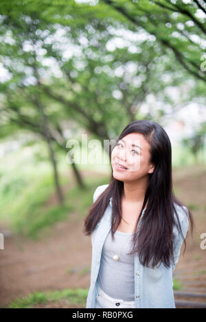 Asian female model poses for pictures on the street Stock Photo