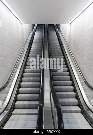 long escalator leading up in an empty train station Stock Photo
