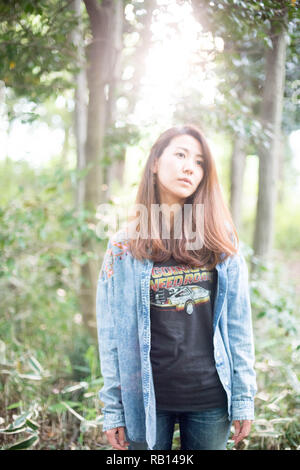 Asian female model poses for pictures on the street Stock Photo