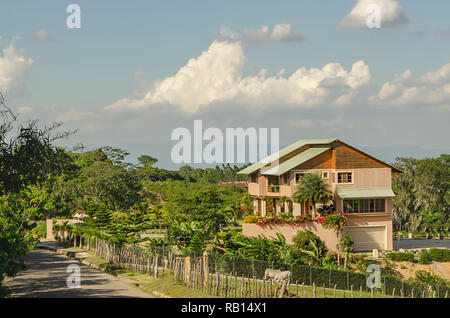 country house on the side of the road with beautiful landscape and surrounded by mountains with a beautiful blue sky Stock Photo