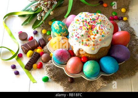 Festive composition in rustic style, Easter meal Breakfast. Easter cake and painted eggs on white wooden table. Stock Photo