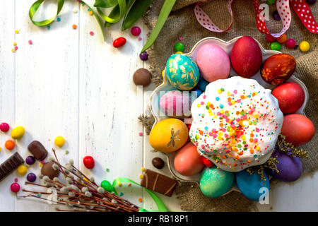 Festive composition in rustic style, Easter meal Breakfast. Easter cake and painted eggs on white wooden table. Top view flat lay background. Copy spa Stock Photo