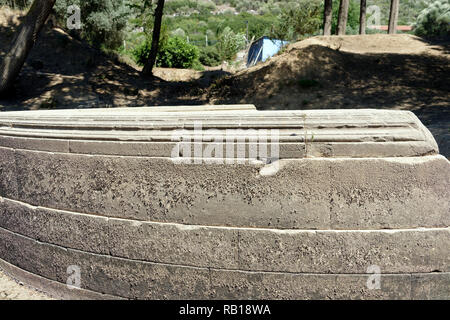 Ancient Greek inscriptions cover the sides and rear of the Exedra at the ancient Greek sanctuary of Apollo of Claros, Izmir province, Turkey.  The Exe Stock Photo