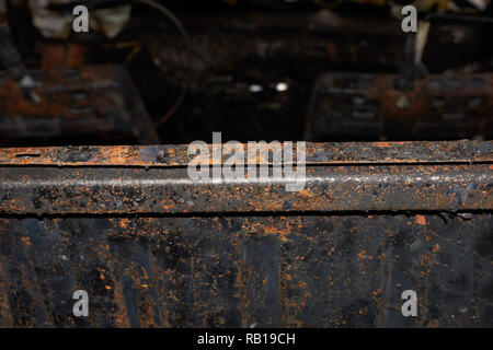 A completely burnt out car with destroyed and rusted interior Stock Photo