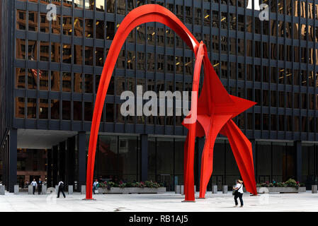 Chicago, Illinois / USA : October 09, 2018 Calder's Flamingo sculpture in the middle of the vibrant public place, Federal Plaza, in Chicago, enclosed 