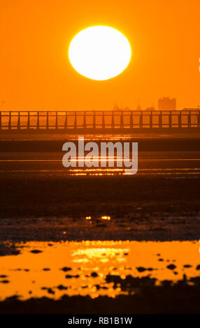 Sun setting over the sea in Autumn on the South Coast of the UK. Stock Photo