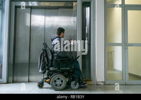 Handicapped male on wheelchair waiting for elevator Stock Photo