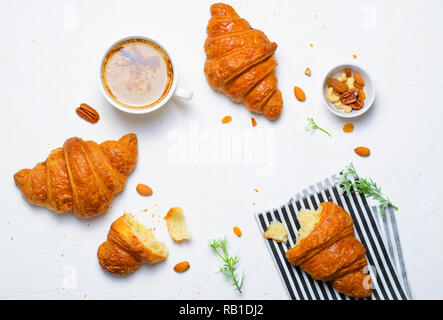 Freshly Baked Croissants and Coffee Cup on White Background, Top View Stock Photo