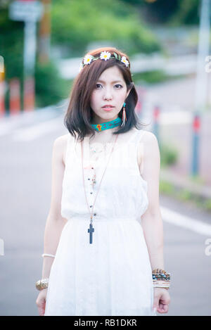 Asian female model poses for pictures on the street Stock Photo