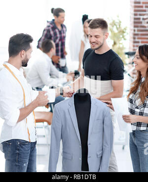 group of designers discuss men's suit Stock Photo